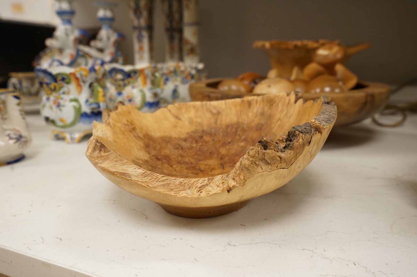 A modern treen yew bowl, a burr wood bowl and various fruit